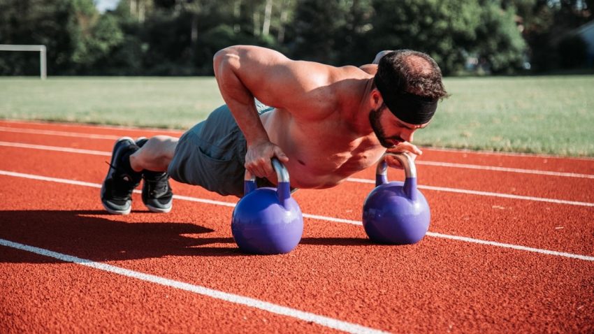 man exercising on field during daytime